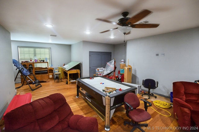 rec room featuring light hardwood / wood-style flooring and ceiling fan