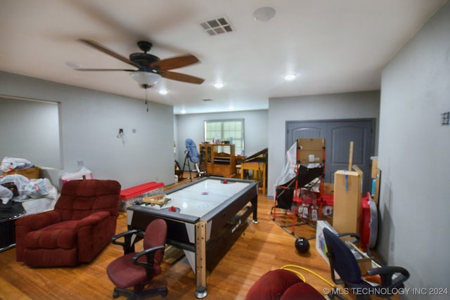 recreation room with light hardwood / wood-style flooring and ceiling fan