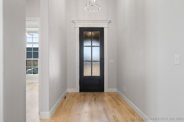 entrance foyer with light wood-style floors and baseboards