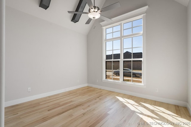 unfurnished room with baseboards, vaulted ceiling, a wealth of natural light, and wood finished floors