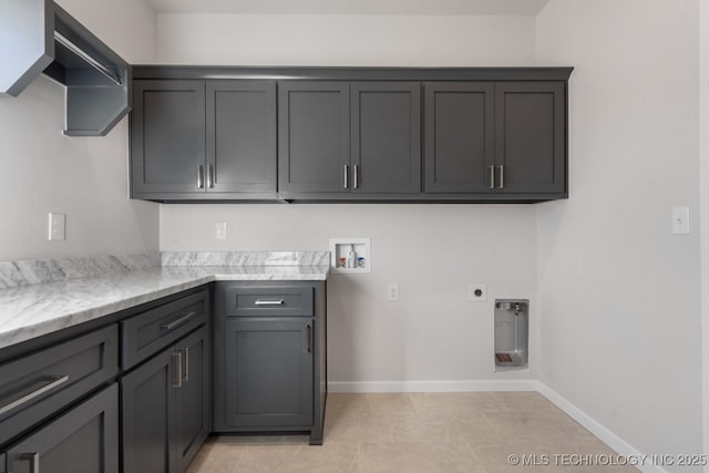 washroom featuring cabinet space, baseboards, washer hookup, and electric dryer hookup