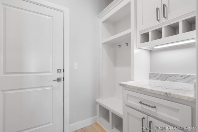 mudroom with light wood-type flooring and baseboards