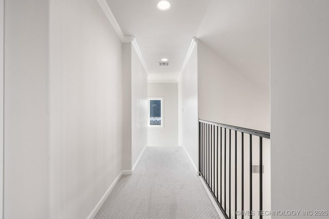 corridor featuring carpet floors, baseboards, crown molding, and recessed lighting