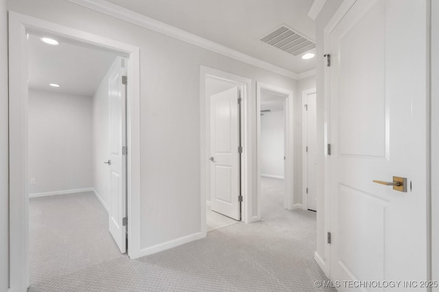 hallway featuring recessed lighting, carpet flooring, visible vents, baseboards, and crown molding