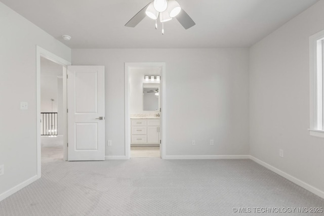 unfurnished bedroom with baseboards, connected bathroom, a ceiling fan, and light colored carpet