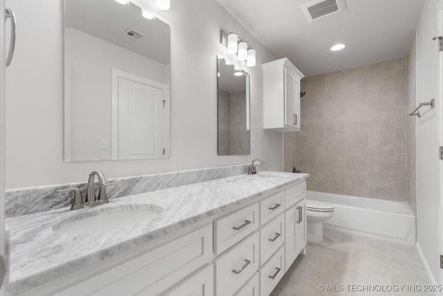 full bath featuring toilet, a sink, and visible vents