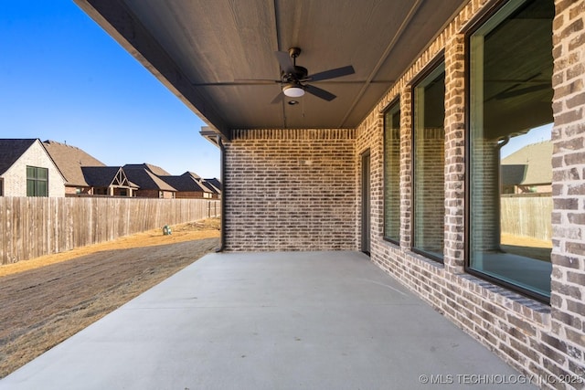 view of patio featuring ceiling fan and fence