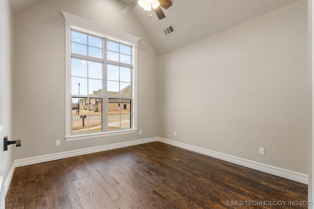 spare room featuring ceiling fan, dark hardwood / wood-style flooring, and vaulted ceiling