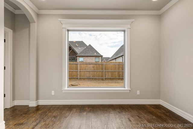 unfurnished room featuring ornamental molding and dark wood-type flooring