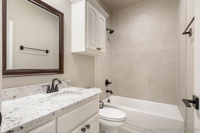 full bathroom featuring toilet, vanity, and tiled shower / bath