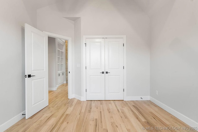 unfurnished bedroom featuring a closet and light hardwood / wood-style flooring