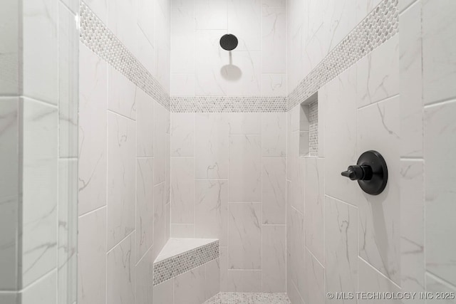 bathroom featuring tiled shower