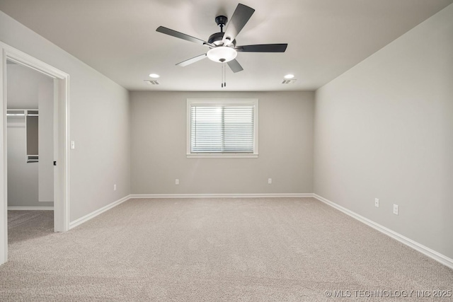 14504 E 80th St, Owasso, OK 74055 - unfurnished bedroom with a walk in closet, baseboards, and light carpet