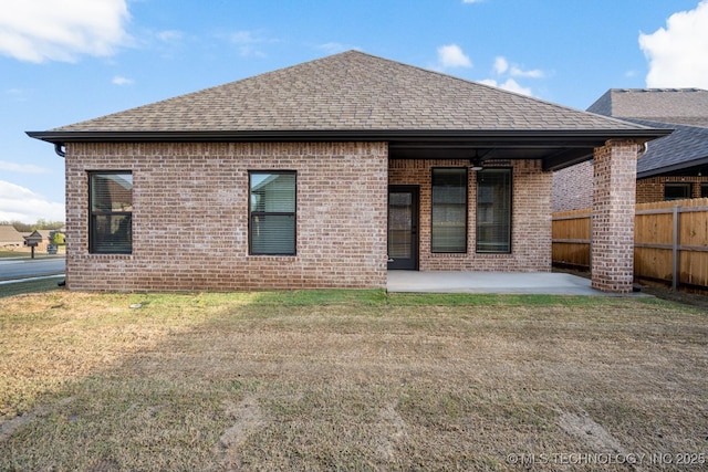 14504 E 80th St, Owasso, OK 74055 - rear view of house featuring fence, a shingled roof, a patio, a lawn, and brick siding