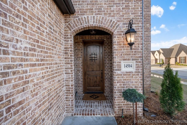 14504 E 80th St, Owasso, OK 74055 - doorway to property featuring brick siding