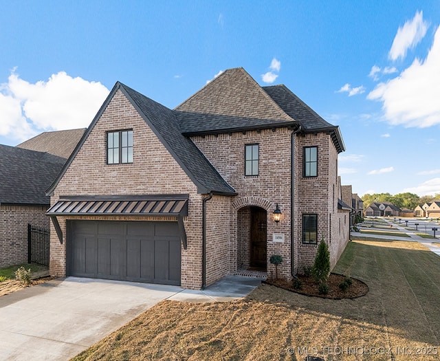 14504 E 80th St, Owasso, OK 74055 - view of front facade featuring concrete driveway, a front lawn, a shingled roof, fence, and brick siding