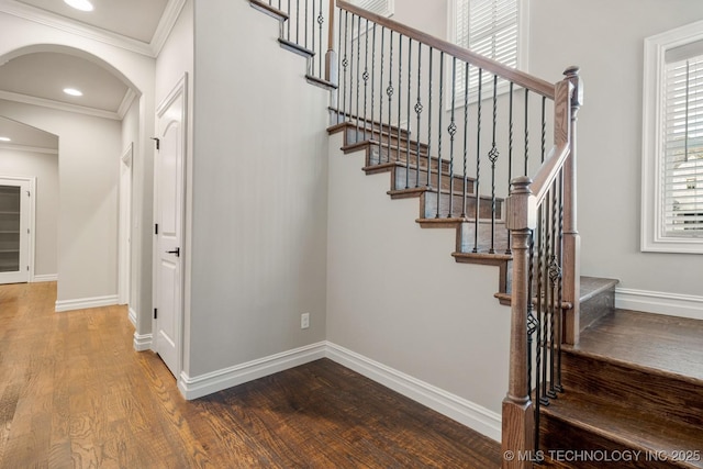 14504 E 80th St, Owasso, OK 74055 - staircase with baseboards, wood finished floors, arched walkways, and ornamental molding