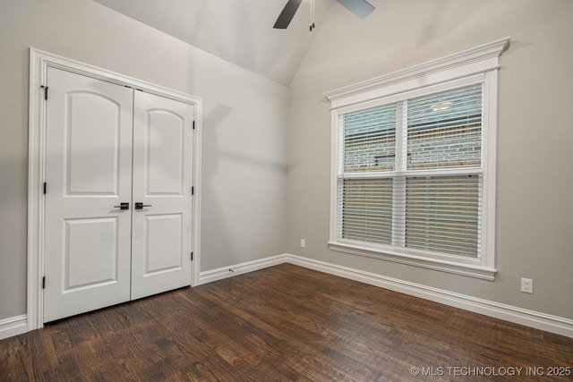14504 E 80th St, Owasso, OK 74055 - unfurnished bedroom with vaulted ceiling, baseboards, dark wood-type flooring, and a closet