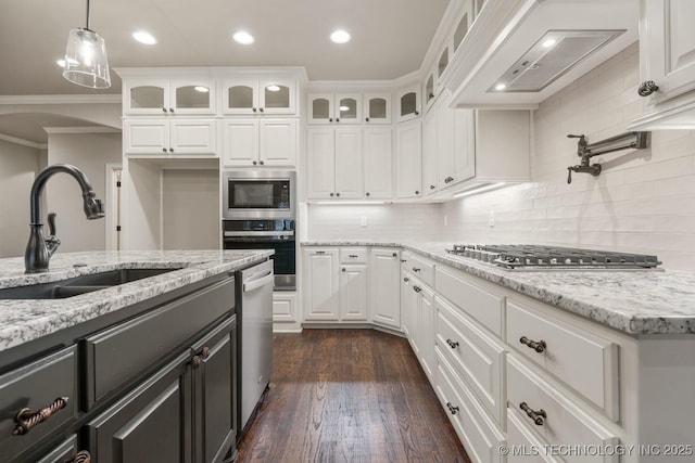 14504 E 80th St, Owasso, OK 74055 - kitchen with crown molding, range hood, a sink, white cabinetry, and appliances with stainless steel finishes