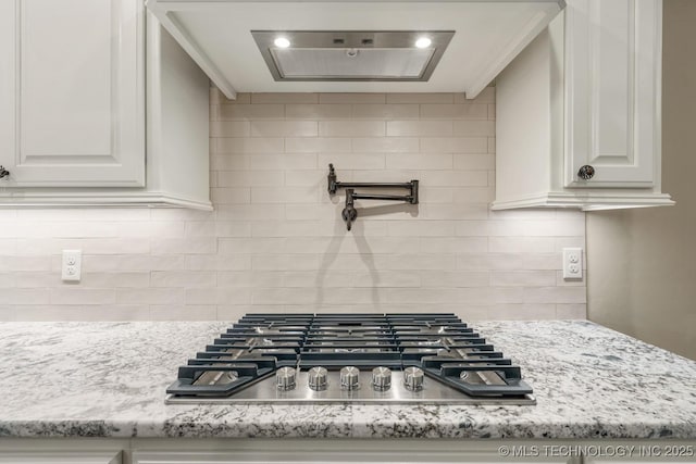14504 E 80th St, Owasso, OK 74055 - kitchen with stainless steel gas cooktop, backsplash, white cabinetry, and light stone countertops