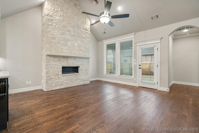 14504 E 80th St, Owasso, OK 74055 - unfurnished living room featuring wood finished floors, visible vents, arched walkways, a fireplace, and ceiling fan