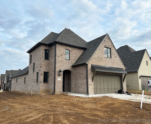 french country style house with a garage