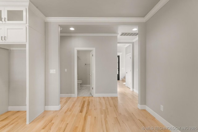 hallway featuring recessed lighting, visible vents, baseboards, ornamental molding, and light wood-type flooring