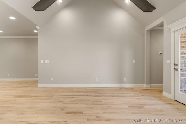 unfurnished room featuring recessed lighting, vaulted ceiling, light wood-style flooring, and baseboards