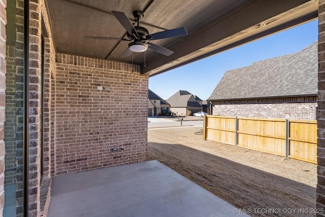 view of patio with a ceiling fan and fence