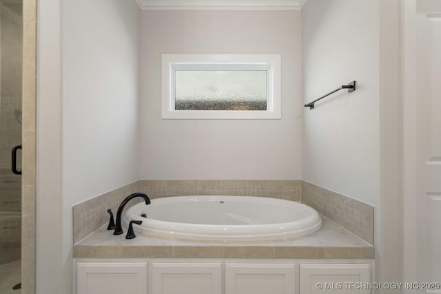 bathroom featuring a stall shower and a garden tub