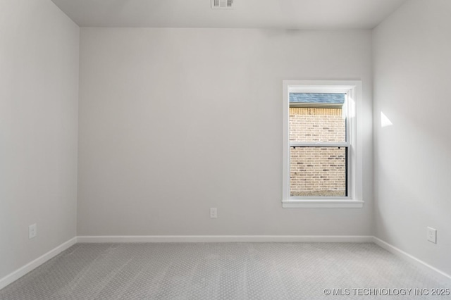 unfurnished room with light carpet, baseboards, and visible vents