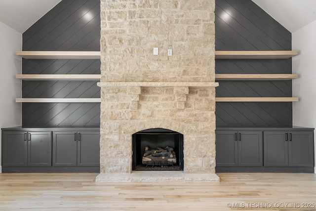 room details featuring a fireplace and wood finished floors