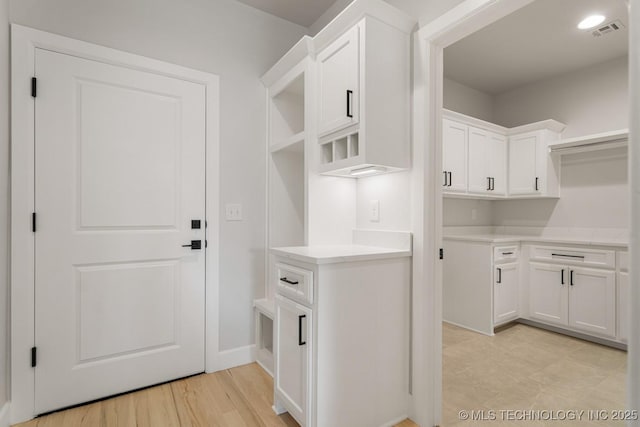 interior space featuring visible vents and light wood finished floors