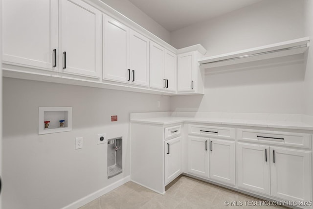 laundry area featuring light tile patterned floors, hookup for an electric dryer, washer hookup, baseboards, and cabinet space