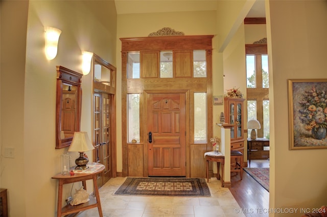 entryway featuring a high ceiling and light hardwood / wood-style flooring