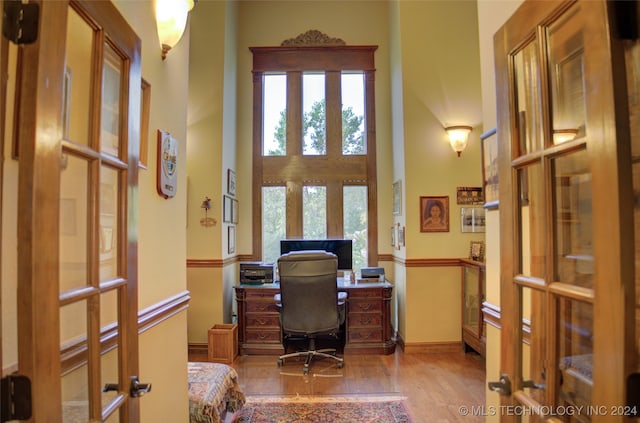 office space with hardwood / wood-style flooring and french doors