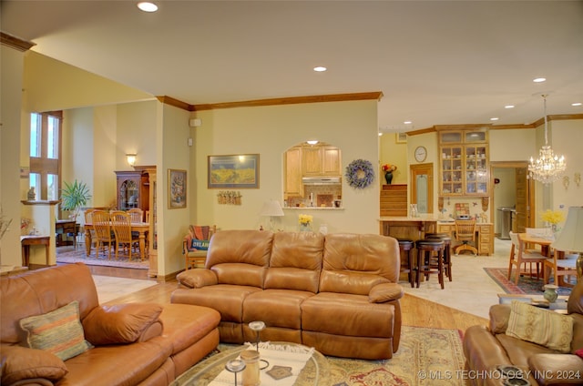 living room featuring crown molding, light hardwood / wood-style floors, and a notable chandelier