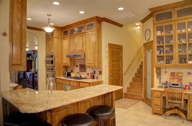 kitchen with pendant lighting, a kitchen bar, light stone counters, and kitchen peninsula