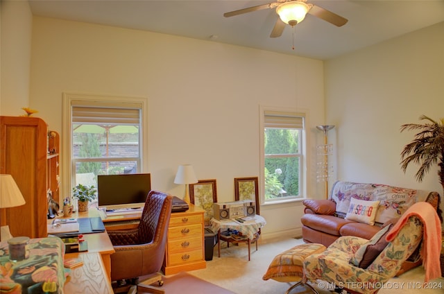 carpeted office space with ceiling fan