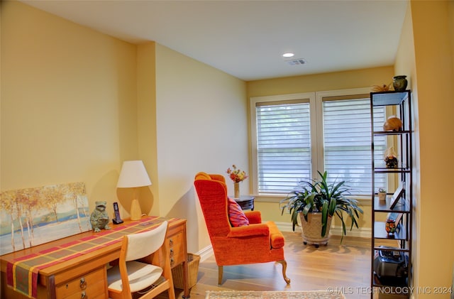 sitting room with wood-type flooring