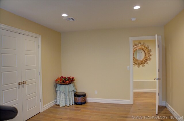 interior space with a closet and light hardwood / wood-style floors