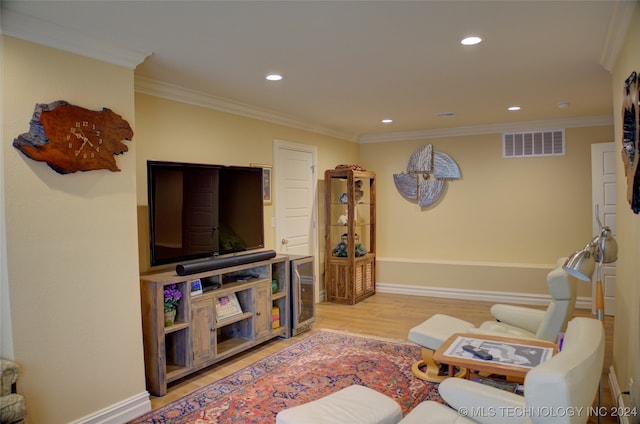 living room featuring crown molding and light hardwood / wood-style flooring