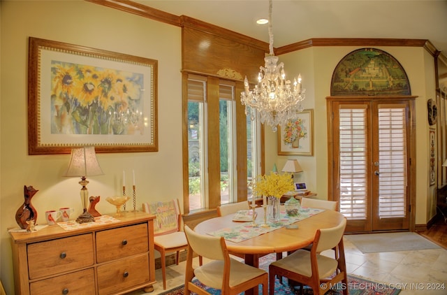 tiled dining space featuring crown molding, a notable chandelier, and french doors