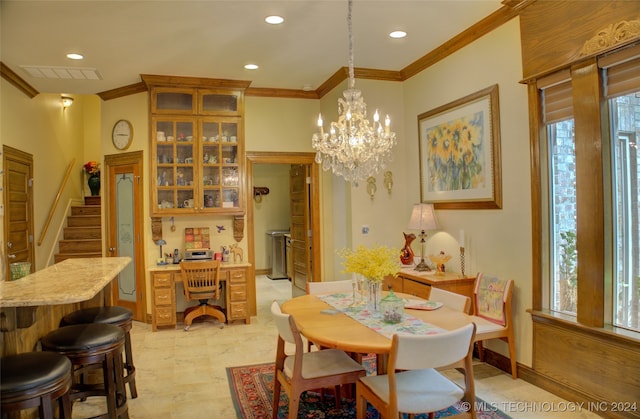 dining space featuring ornamental molding, plenty of natural light, and an inviting chandelier