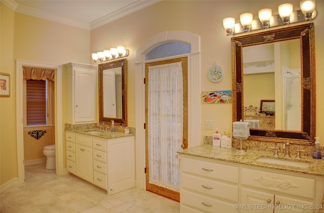 bathroom featuring toilet, ornamental molding, and vanity