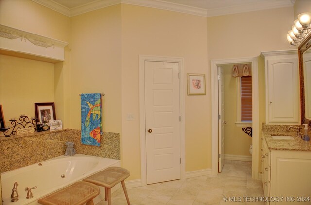 bathroom featuring vanity, tile patterned flooring, crown molding, toilet, and a bathtub