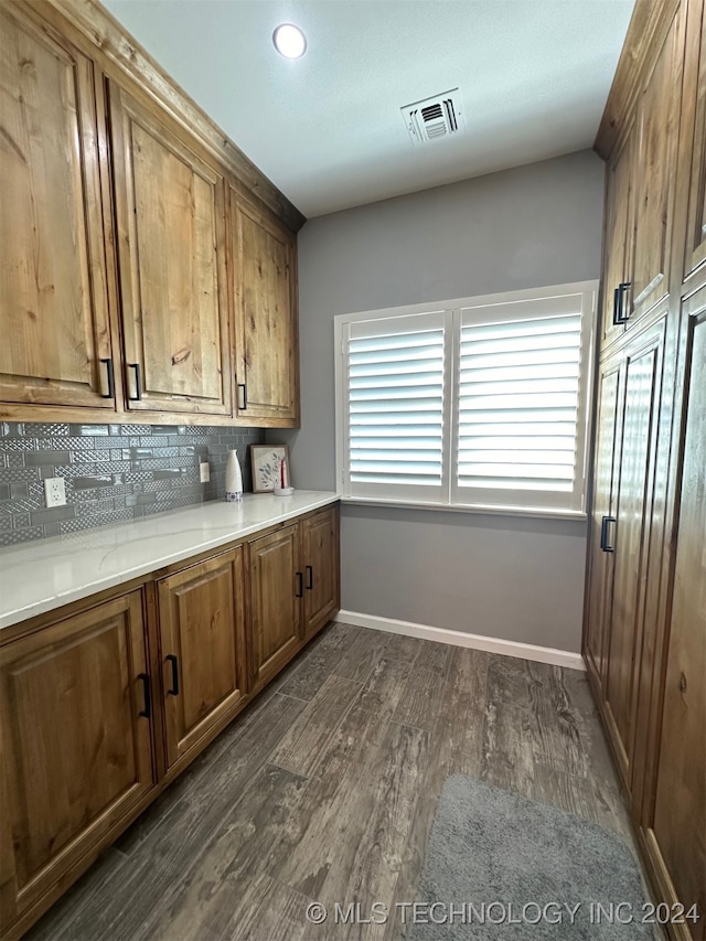 kitchen featuring backsplash and dark hardwood / wood-style floors