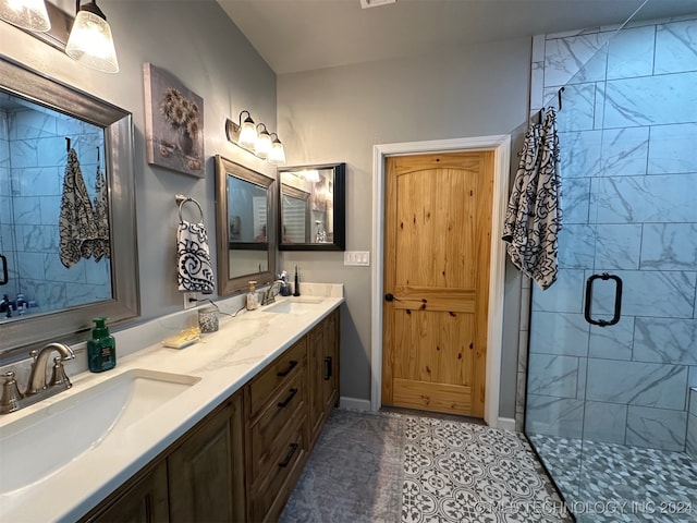 bathroom featuring tile patterned floors, a shower with shower door, and vanity