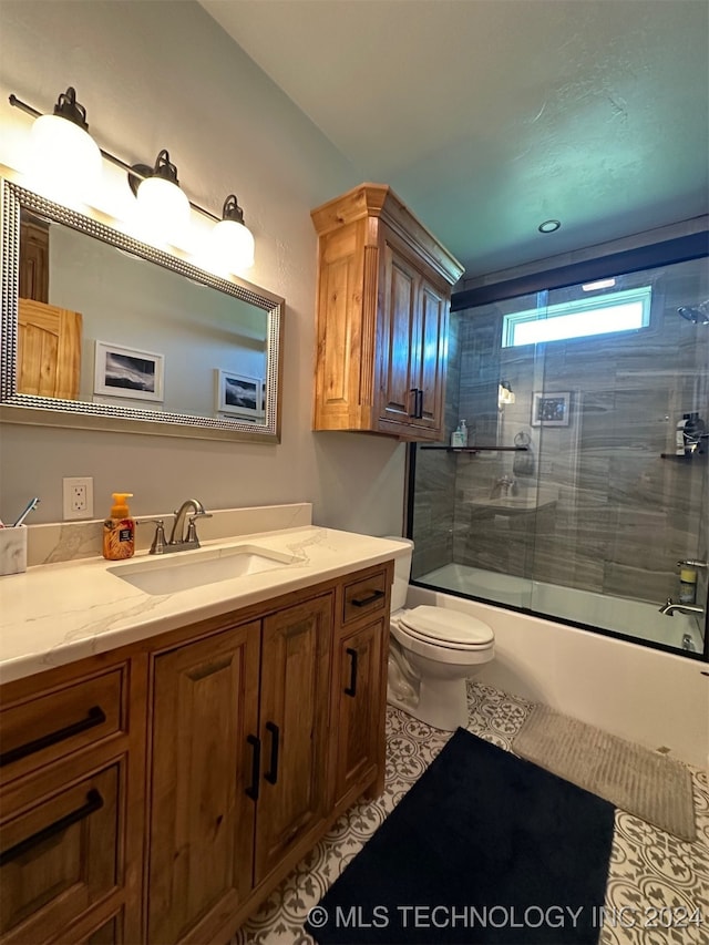 full bathroom featuring shower / bath combination with glass door, vanity, toilet, and tile patterned floors