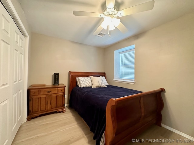 bedroom with a closet, ceiling fan, and light hardwood / wood-style floors